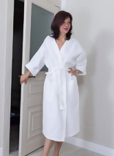 Beautiful milf masturbates lying on the bed and strokes her hairy pussy