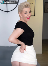 The dyed blonde slowly pulls down her miniskirt and starts caressing her pussy with her fingers