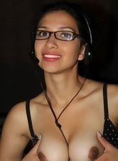 Charming naked secretary in glasses strokes her hairy pussy at work