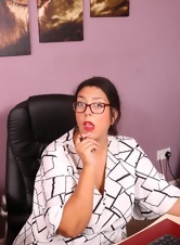 A secretary with a hairy pussy and beautiful glasses very sexy fondles her pussy with a finger