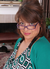 Bespectacled mature lady showing her big belly, natural boobs